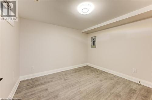 Empty room featuring light wood-type flooring and electric panel - 1100 Union Street Unit# 3, Kitchener, ON - Indoor Photo Showing Other Room