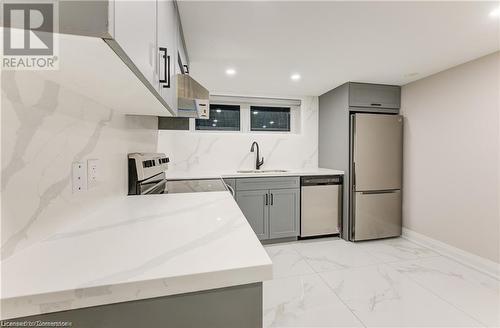 Kitchen with gray cabinetry, sink, stainless steel appliances, and extractor fan - 1100 Union Street Unit# 3, Kitchener, ON - Indoor Photo Showing Kitchen