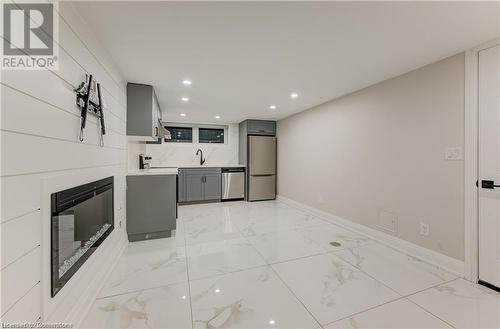 Kitchen featuring backsplash, gray cabinets, stainless steel appliances, and sink - 1100 Union Street Unit# 3, Kitchener, ON - Indoor