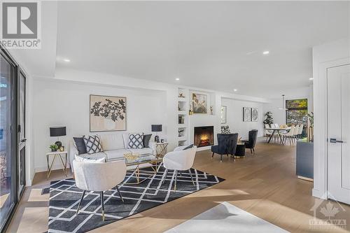 Fireplace insert is plain not Herringbone - 139 Winther Avenue, Ottawa, ON - Indoor Photo Showing Living Room With Fireplace