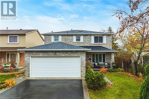 View of front of property with a front yard and a garage - 145 Dragoon Drive, Hamilton, ON - Outdoor With Facade