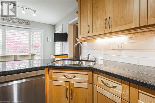 Kitchen featuring backsplash, dishwasher, and sink - 145 Dragoon Drive, Hamilton, ON - Indoor Photo Showing Kitchen With Double Sink