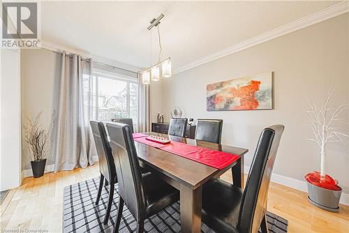 Dining space with crown molding, light hardwood / wood-style flooring, and a textured ceiling - 145 Dragoon Drive, Hamilton, ON - Indoor Photo Showing Dining Room