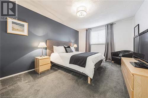 Bedroom with dark carpet and a textured ceiling - 145 Dragoon Drive, Hamilton, ON - Indoor Photo Showing Bedroom