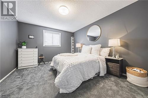 Carpeted bedroom with a textured ceiling - 145 Dragoon Drive, Hamilton, ON - Indoor Photo Showing Bedroom