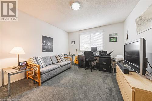 Office space featuring a textured ceiling and dark carpet - 145 Dragoon Drive, Hamilton, ON - Indoor