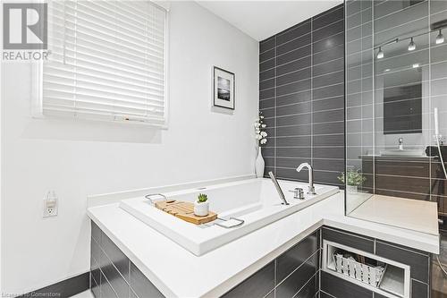 Bathroom with a relaxing tiled tub - 145 Dragoon Drive, Hamilton, ON - Indoor Photo Showing Bathroom