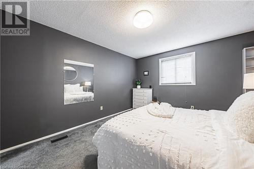 Carpeted bedroom featuring a textured ceiling - 145 Dragoon Drive, Hamilton, ON - Indoor Photo Showing Bedroom