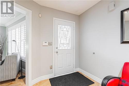 Foyer entrance featuring light wood-type flooring and crown molding - 145 Dragoon Drive, Hamilton, ON - Indoor Photo Showing Other Room