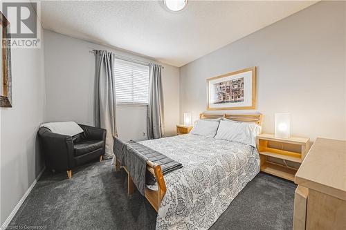 Carpeted bedroom with a textured ceiling - 145 Dragoon Drive, Hamilton, ON - Indoor Photo Showing Bedroom