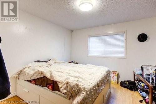 Bedroom featuring a textured ceiling and light hardwood / wood-style floors - 539 Briarwood Avenue, Listowel, ON - Indoor Photo Showing Bedroom