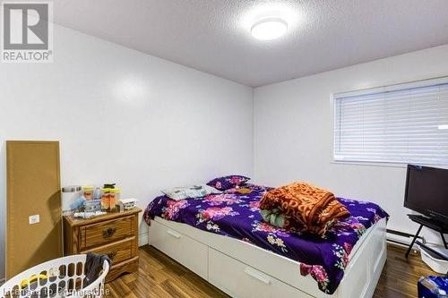 Bedroom with wood-type flooring and a textured ceiling - 539 Briarwood Avenue, Listowel, ON - Indoor Photo Showing Bedroom