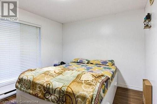 Bedroom with a baseboard radiator and dark wood-type flooring - 539 Briarwood Avenue, Listowel, ON - Indoor Photo Showing Bedroom