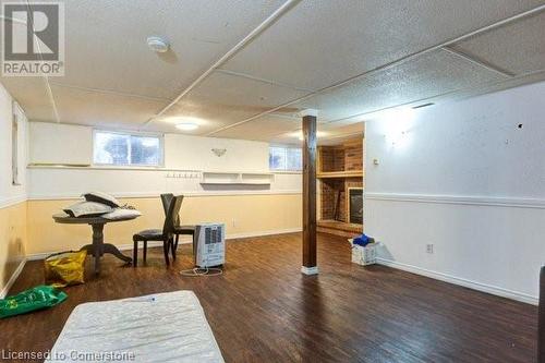 Exercise area with dark hardwood / wood-style flooring and a textured ceiling - 539 Briarwood Avenue, Listowel, ON - Indoor