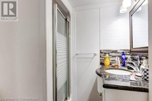 Bathroom with vanity, walk in shower, and tasteful backsplash - 539 Briarwood Avenue, Listowel, ON - Indoor Photo Showing Bathroom