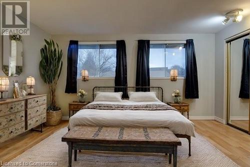 Virtual Staged Bedroom featuring light hardwood / wood-style flooring and multiple windows - 116 Glamis Road, Cambridge, ON - Indoor Photo Showing Bedroom