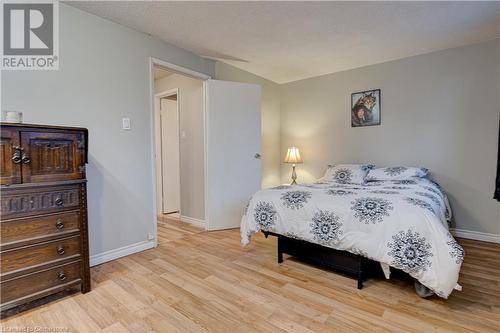 Bedroom with light hardwood / wood-style floors and a textured ceiling - 116 Glamis Road, Cambridge, ON - Indoor Photo Showing Bedroom