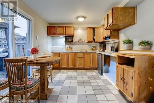 Virtual Staged Kitchen featuring stainless steel dishwasher, light tile patterned flooring, sink, and tasteful backsplash - 116 Glamis Road, Cambridge, ON - Indoor Photo Showing Kitchen