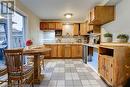 Virtual Staged Kitchen featuring stainless steel dishwasher, light tile patterned flooring, sink, and tasteful backsplash - 116 Glamis Road, Cambridge, ON  - Indoor Photo Showing Kitchen 