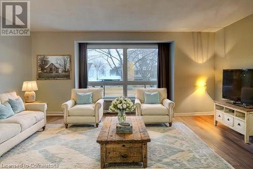 Virtual Staged Living room featuring wood-type flooring - 116 Glamis Road, Cambridge, ON - Indoor Photo Showing Living Room