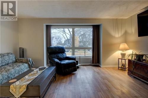 Living room featuring a textured ceiling and light hardwood / wood-style flooring - 116 Glamis Road, Cambridge, ON - Indoor Photo Showing Other Room