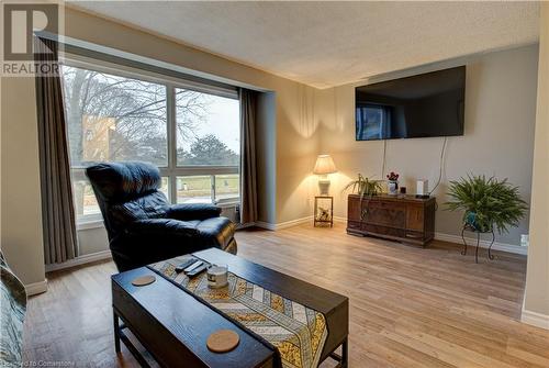 Living room featuring a textured ceiling and hardwood / wood-style flooring - 116 Glamis Road, Cambridge, ON - Indoor Photo Showing Living Room