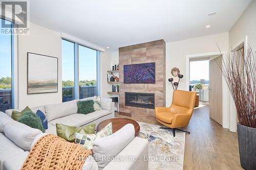 604 - 57 Lakeport Road, St. Catharines (Port Dalhousie), ON - Indoor Photo Showing Living Room With Fireplace