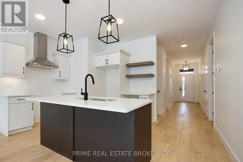 1 - 110 Coastal Crescent, Lambton Shores (Grand Bend), ON - Indoor Photo Showing Kitchen With Double Sink