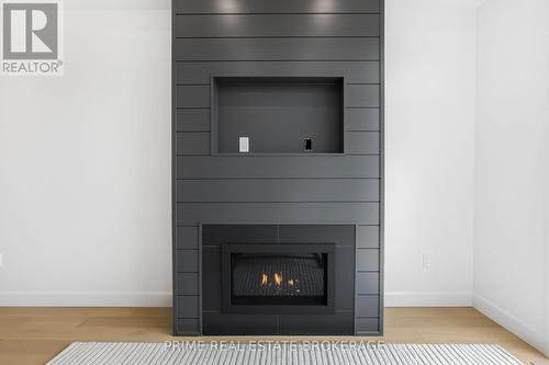 49 - 14 Coastal Crescent, Lambton Shores (Grand Bend), ON - Indoor Photo Showing Living Room With Fireplace