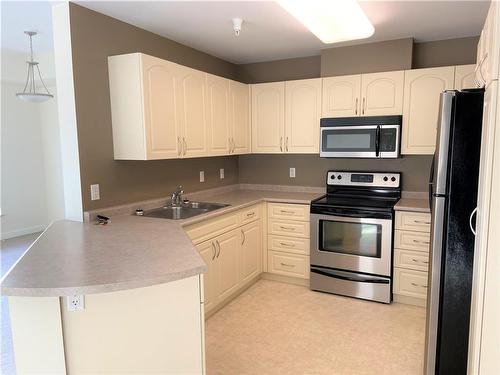 314 457 9Th Street, Brandon, MB - Indoor Photo Showing Kitchen With Double Sink