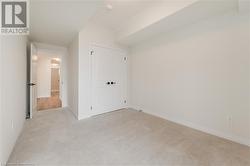 Unfurnished bedroom with light carpet and a closet - 