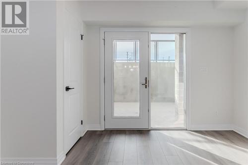 Doorway to outside with light hardwood / wood-style floors - 142 Foamflower Place Unit# D053, Waterloo, ON - Indoor Photo Showing Other Room