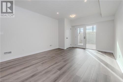 Empty room with light hardwood / wood-style floors - 142 Foamflower Place Unit# D053, Waterloo, ON - Indoor Photo Showing Other Room