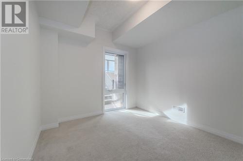 Spare room featuring light colored carpet - 142 Foamflower Place Unit# D053, Waterloo, ON - Indoor Photo Showing Other Room