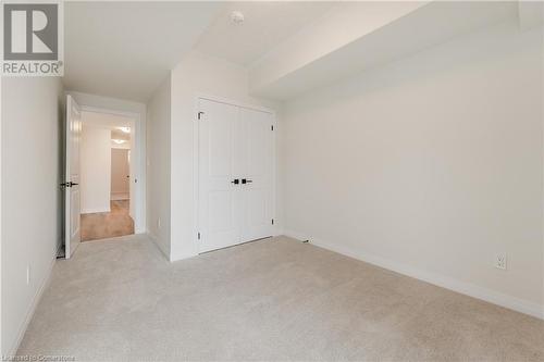 Unfurnished bedroom with light carpet and a closet - 142 Foamflower Place Unit# D053, Waterloo, ON - Indoor Photo Showing Other Room