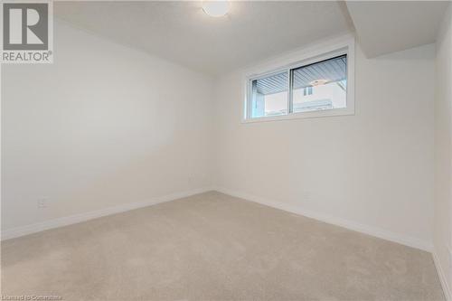 View of carpeted empty room - 142 Foamflower Place Unit# D053, Waterloo, ON - Indoor Photo Showing Other Room