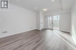 Empty room with light hardwood / wood-style floors - 