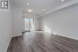 Empty room with hardwood / wood-style floors and french doors - 