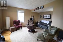 Living room with wood-type flooring - 