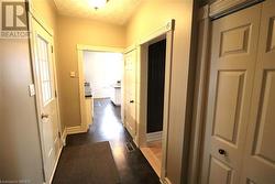 Hallway with dark hardwood / wood-style floors - 