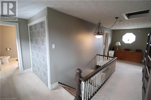 Stairs featuring carpet flooring and a textured ceiling - 92 First Street, Sturgeon Falls, ON - Indoor Photo Showing Other Room