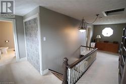 Stairs featuring carpet flooring and a textured ceiling - 