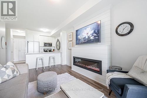 129 - 35 Southshore Crescent, Hamilton, ON - Indoor Photo Showing Living Room With Fireplace