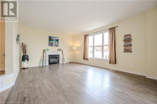 Unfurnished living room with light hardwood / wood-style floors - 584 Winterburg Walk, Waterloo, ON - Indoor Photo Showing Living Room With Fireplace