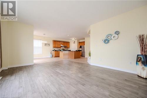 Unfurnished living room featuring light hardwood / wood-style flooring - 584 Winterburg Walk, Waterloo, ON - Indoor