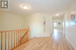 Hallway featuring light wood-type flooring - 