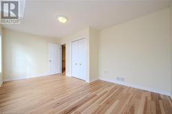 Unfurnished bedroom with a closet, light hardwood / wood-style flooring, and a skylight - 