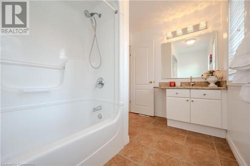 Bathroom with tile patterned flooring, vanity, and washtub / shower combination - 584 Winterburg Walk, Waterloo, ON - Indoor Photo Showing Bathroom