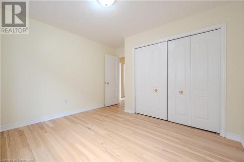 Unfurnished bedroom featuring a closet and light hardwood / wood-style floors - 584 Winterburg Walk, Waterloo, ON - Indoor Photo Showing Other Room