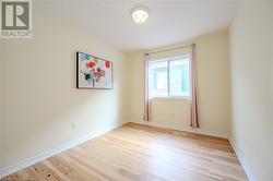 Empty room with light wood-type flooring - 